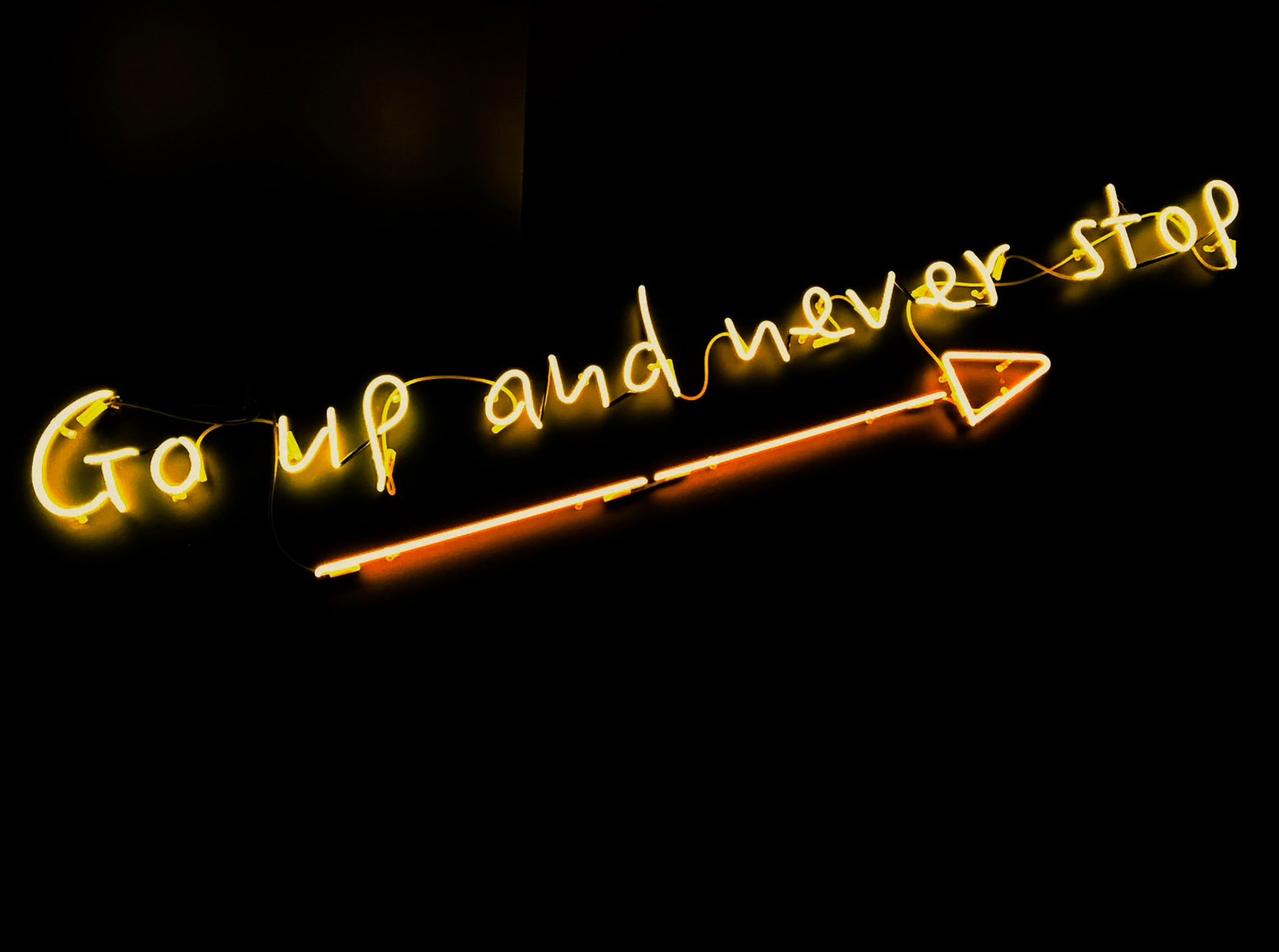 neon saying 'go up and never stop'