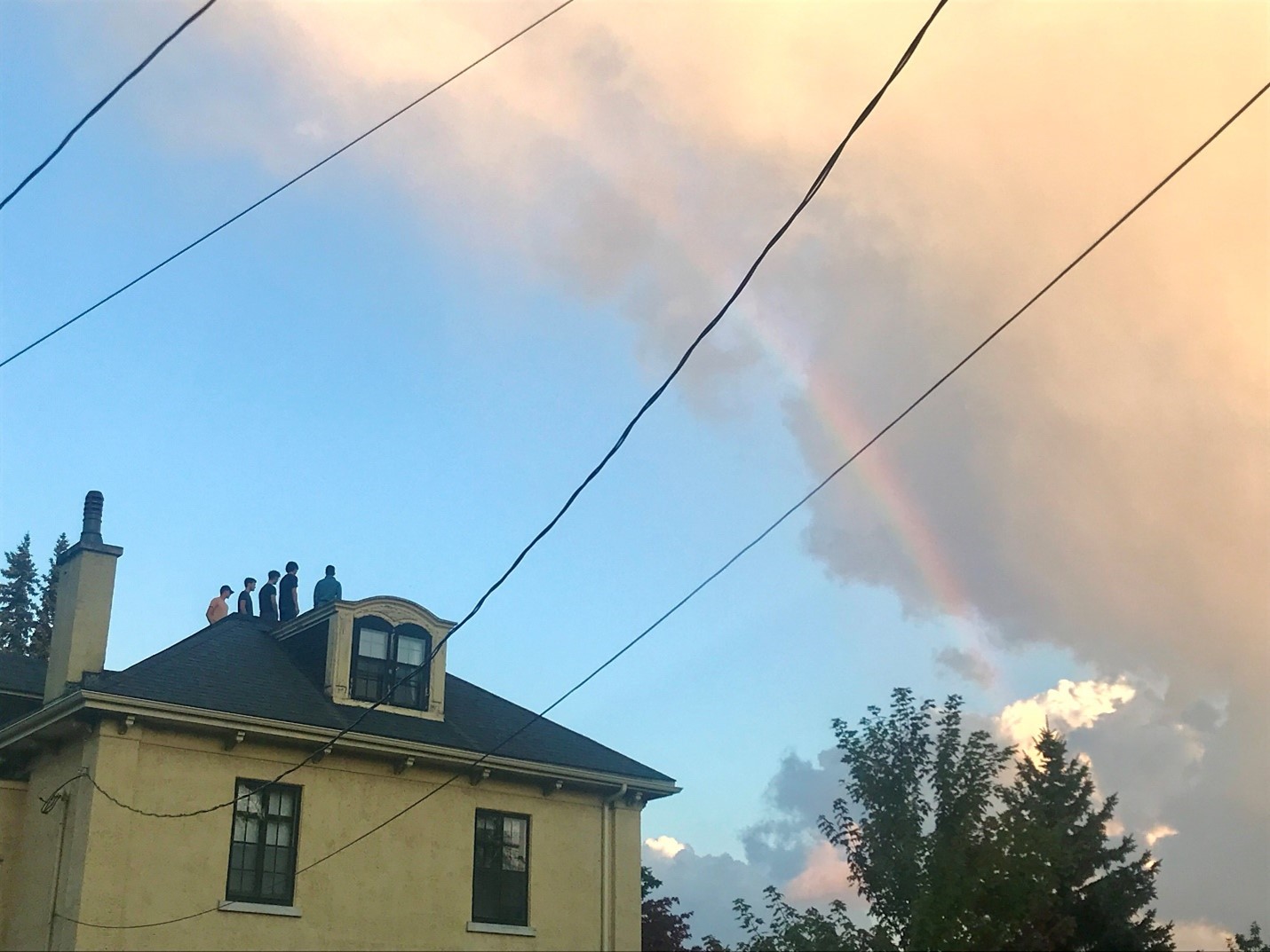 house and a rainbow in the sky