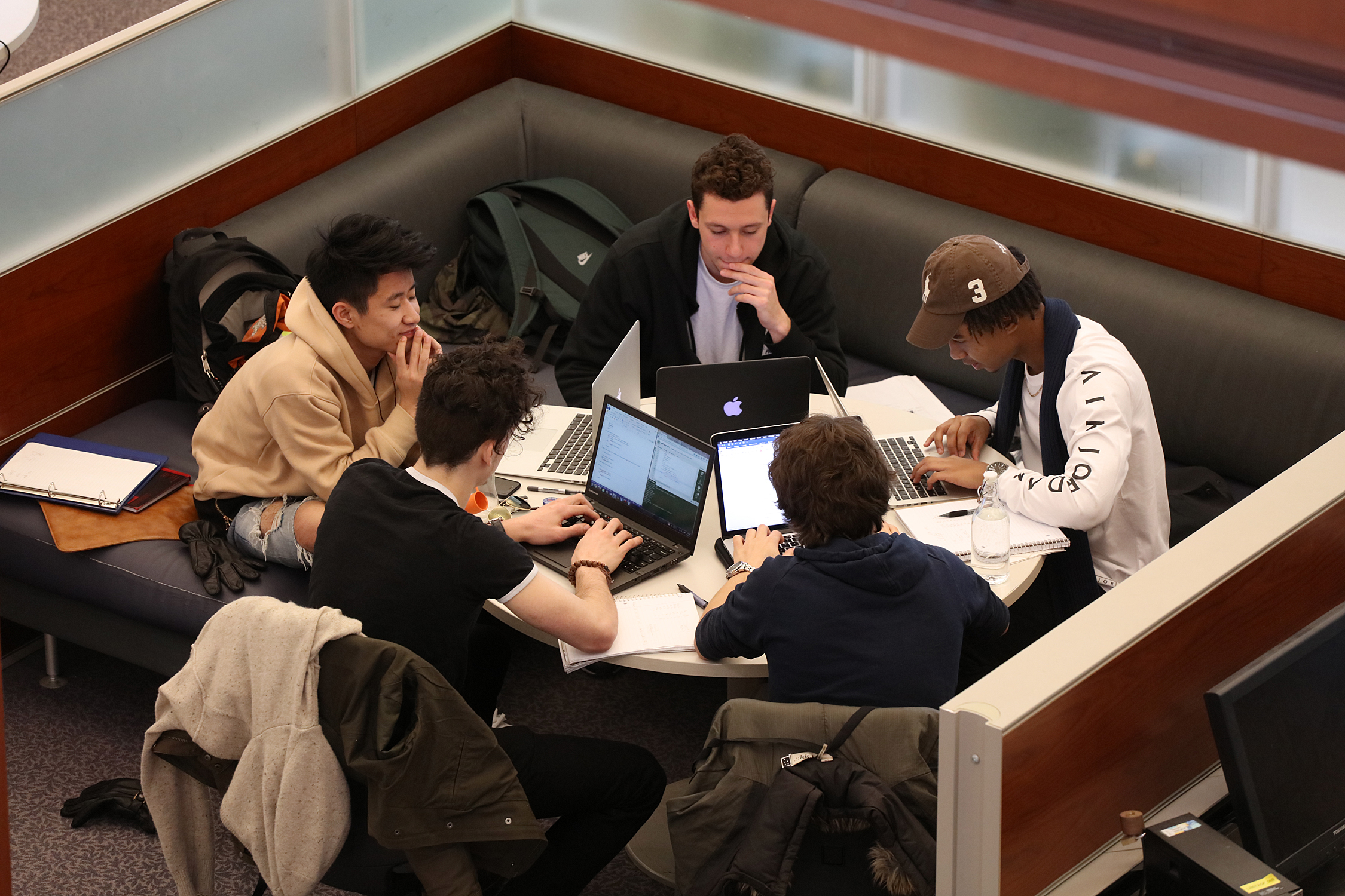 Group of students having a study session and brainstorming together.