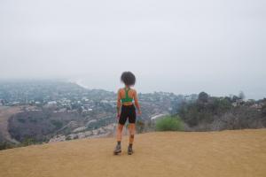 Woman on a mountain top, looking out