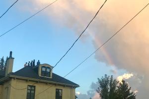house and a rainbow in the sky