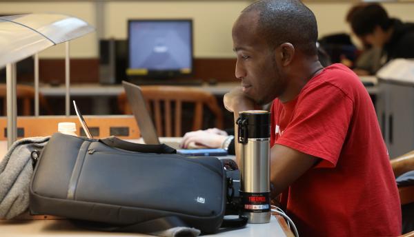 Student on laptop in library