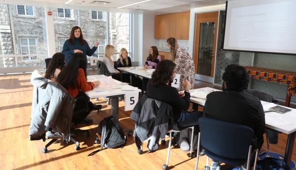 students sitting in a workshop listening to presenter