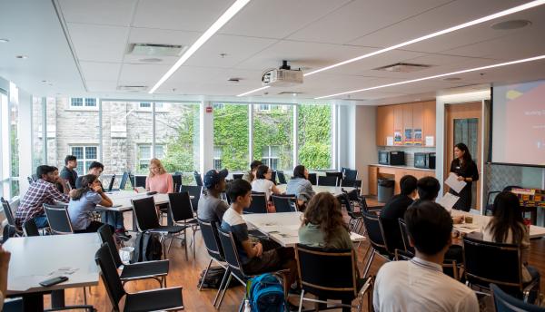 students at desks watching a presentation