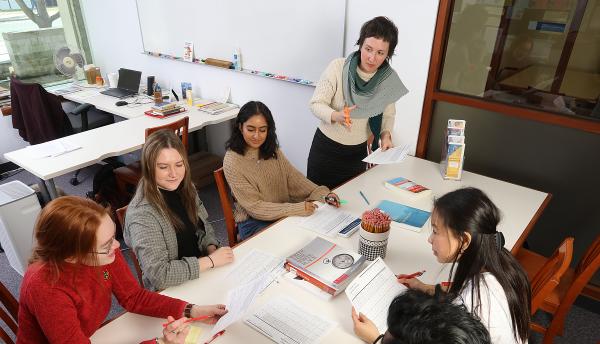Group of students having a study session with a SASS member leading the focus. 