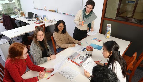 Group of students having a study session with a SASS member leading the focus. 