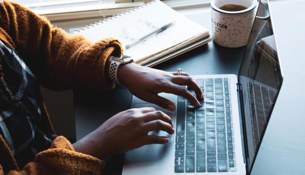 Person typing on keyboard