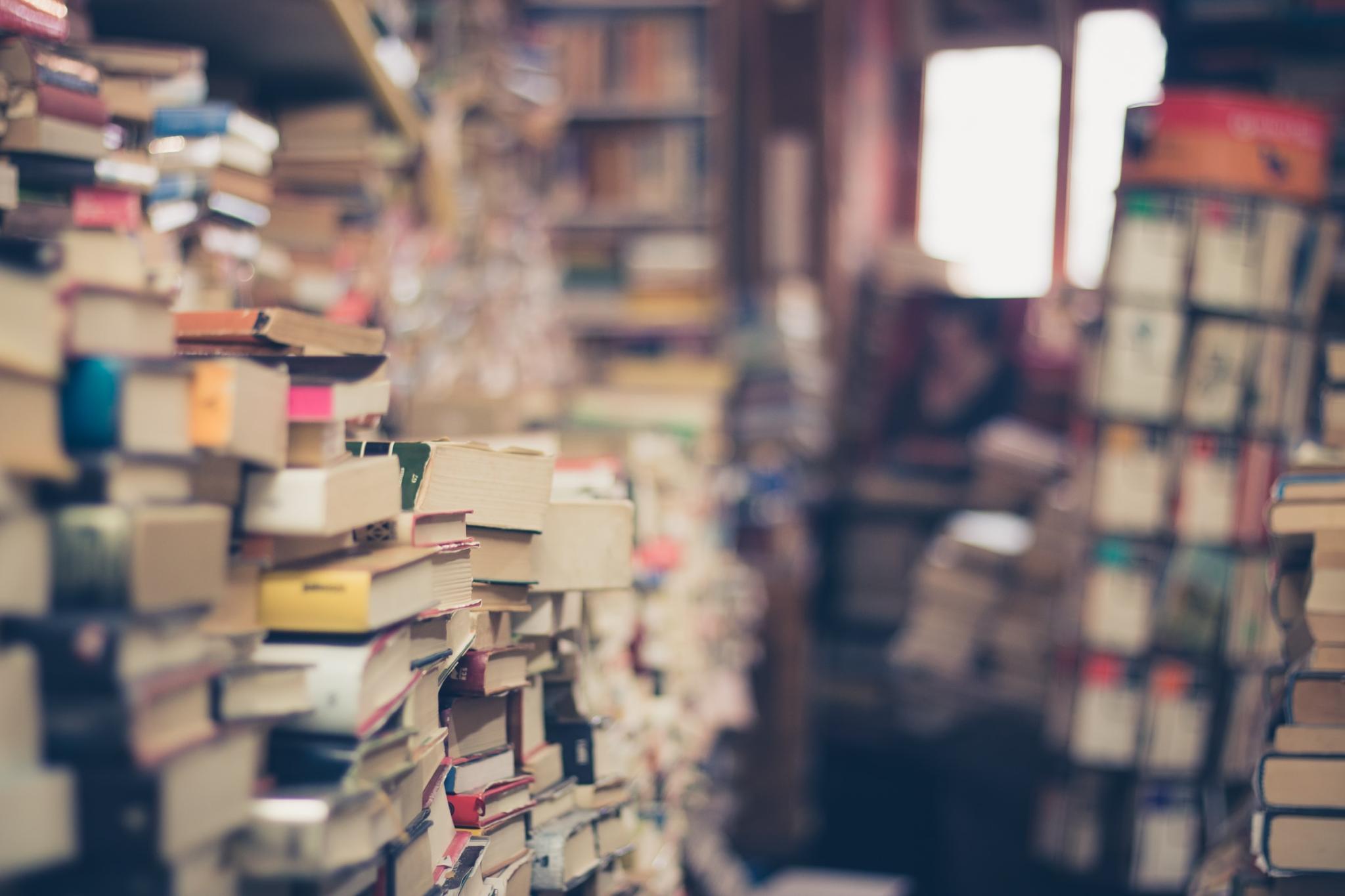 messy stacks of books in a bookshop