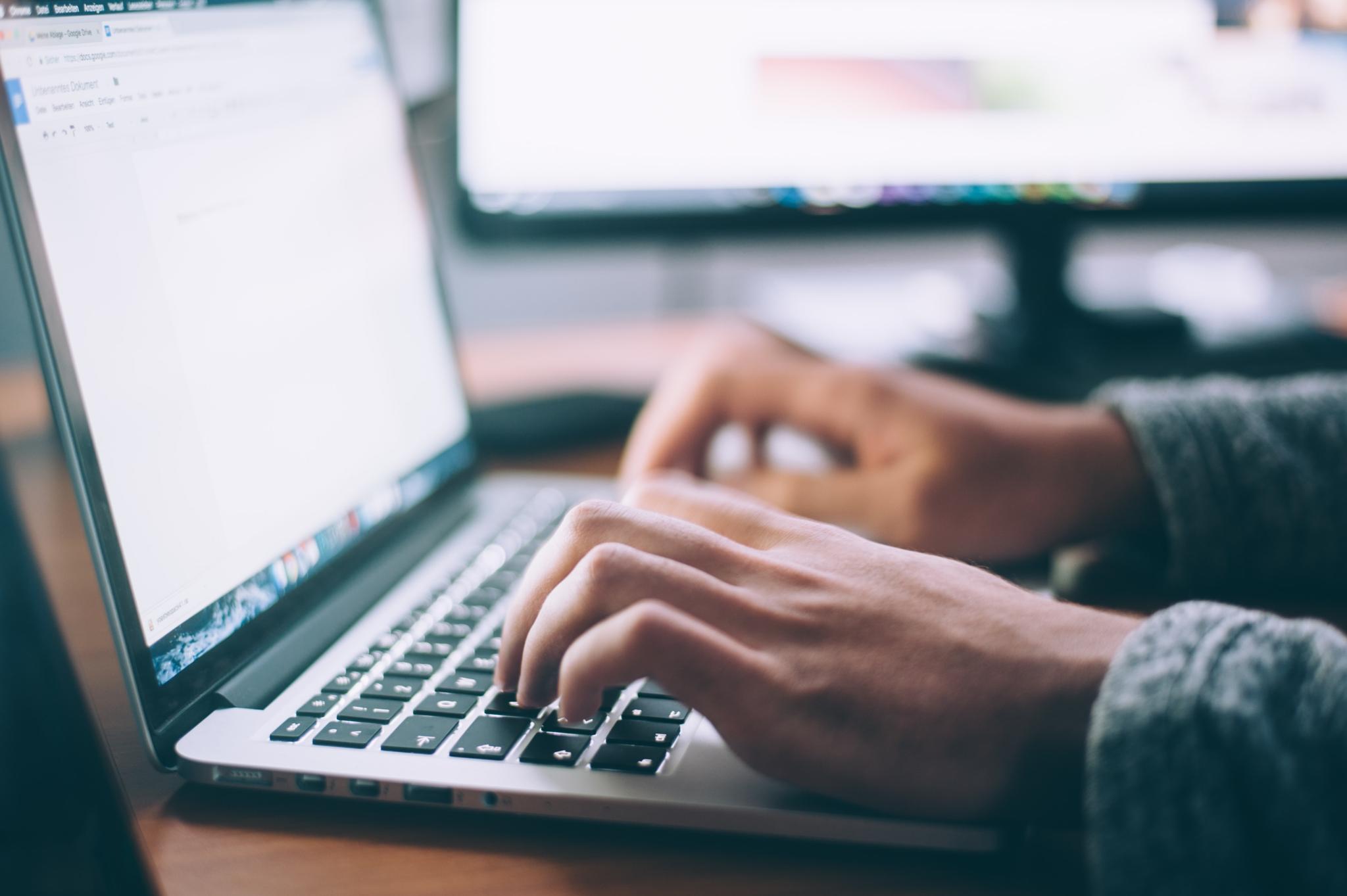 decorative - hands typing on a laptop